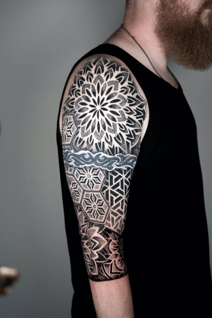 Photo of geometric sleeve tattoo completed by Brad Reis