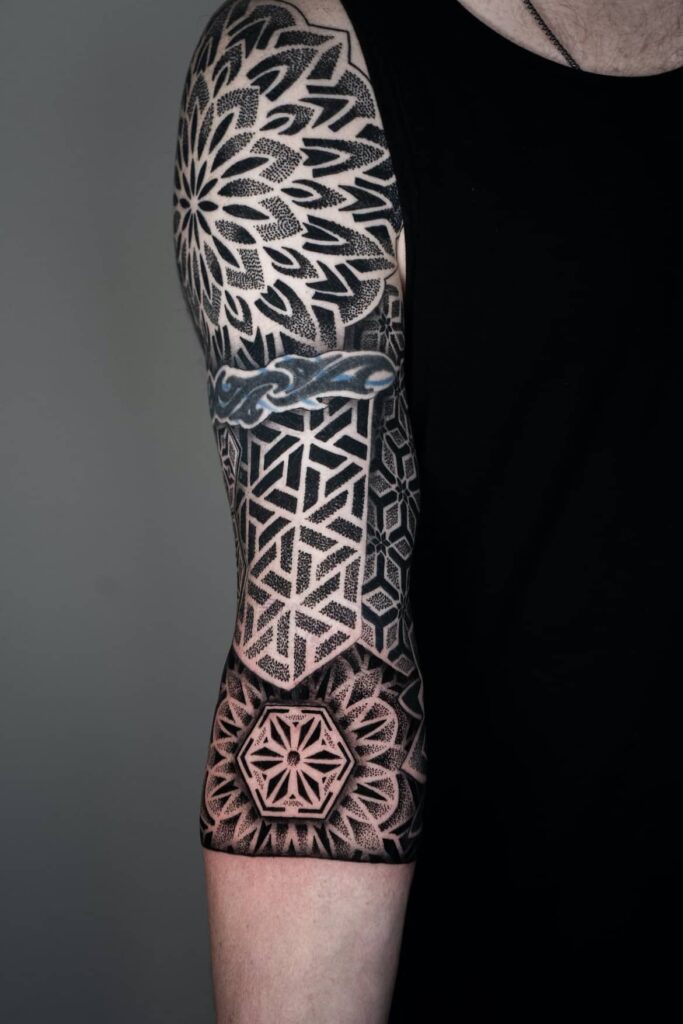 Photo of geometric sleeve tattoo completed by Brad Reis