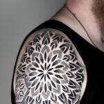 Geometric mandala tattoo on shoulder