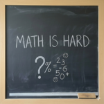 Chalkboard with math is hard written on it.